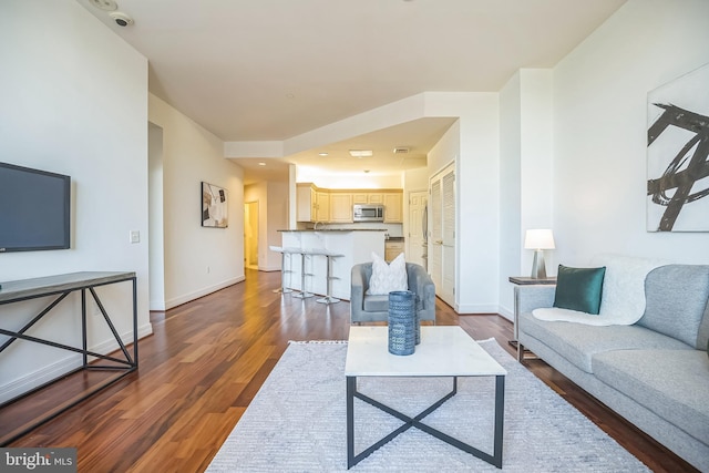 living room with baseboards and wood finished floors