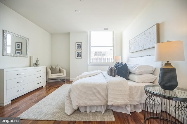 bedroom with visible vents, dark wood-style flooring, and baseboards