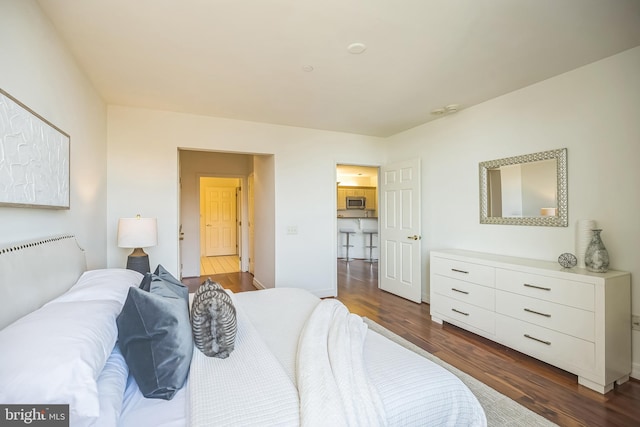 bedroom featuring baseboards and dark wood finished floors