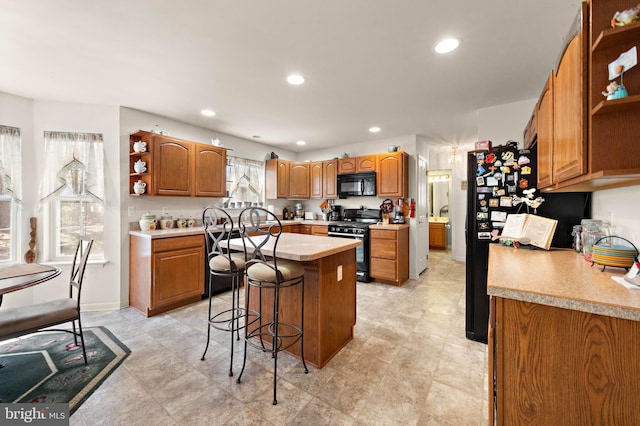 191 Willets Ave, Little Egg Harbor Twp, NJ 08087 - kitchen with brown cabinetry, open shelves, a kitchen breakfast bar, light countertops, and black appliances