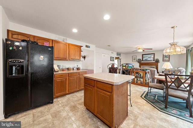 191 Willets Ave, Little Egg Harbor Twp, NJ 08087 - kitchen featuring brown cabinets, ceiling fan, black fridge, light countertops, and a kitchen island