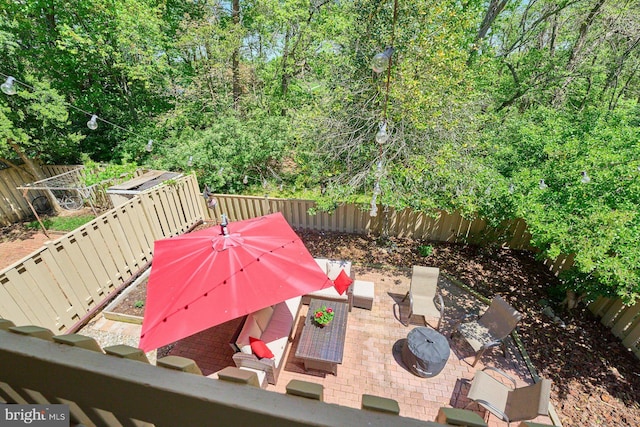 exterior space with a fenced backyard, an outdoor hangout area, and a patio area