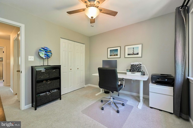 office space featuring carpet flooring, ceiling fan, and baseboards