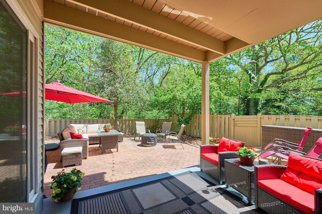 view of patio / terrace featuring a fenced backyard and an outdoor living space with a fire pit