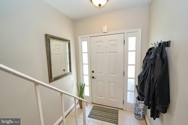 foyer entrance with plenty of natural light and light tile patterned floors