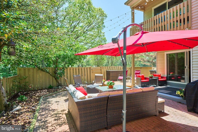 view of patio with a fenced backyard, outdoor lounge area, and a balcony