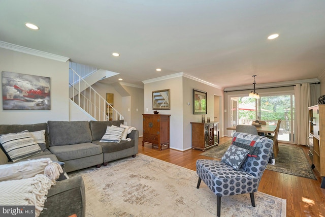 living area with crown molding, recessed lighting, stairs, and wood finished floors