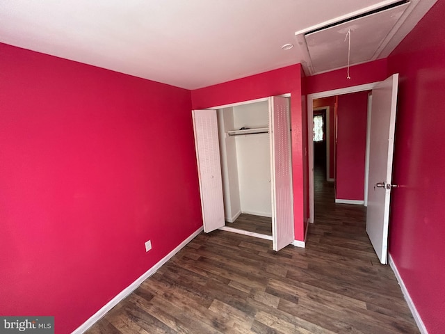 465 Barrister Pl, Dover, DE 19901 - unfurnished bedroom featuring baseboards, wood finished floors, attic access, and a closet