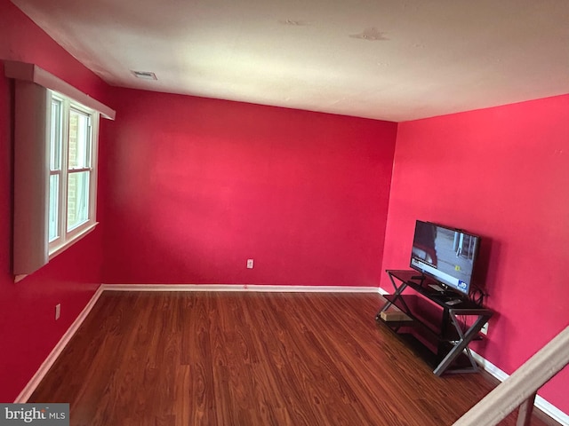 465 Barrister Pl, Dover, DE 19901 - unfurnished living room with visible vents, baseboards, and wood finished floors
