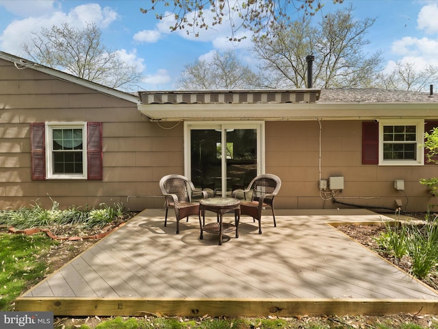 rear view of property featuring an outdoor hangout area and a wooden deck
