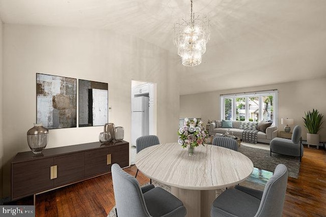 dining room featuring a chandelier and dark wood-type flooring