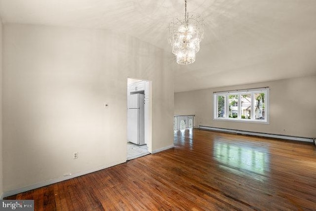 unfurnished living room with baseboards, baseboard heating, a chandelier, and wood finished floors