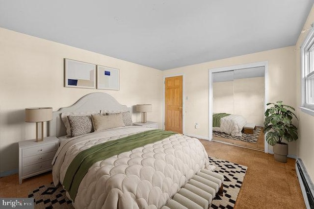 carpeted bedroom with baseboard heating