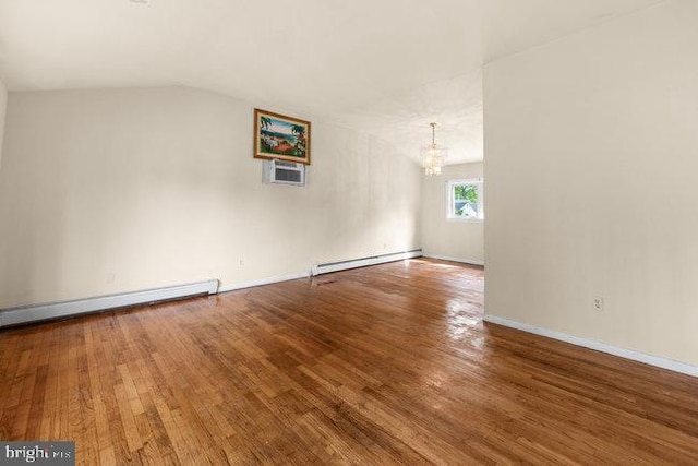 unfurnished room with vaulted ceiling, a baseboard radiator, an inviting chandelier, and wood finished floors