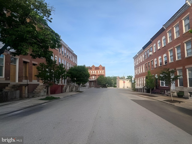 view of road with sidewalks and curbs