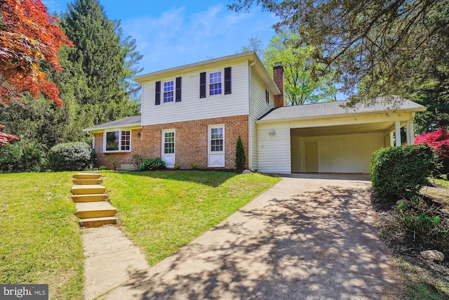 traditional-style house with concrete driveway, brick siding, a chimney, and a front yard