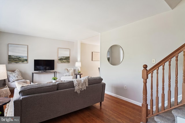 living room with baseboards, stairs, and wood finished floors