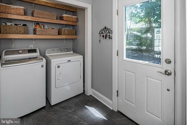 laundry area featuring baseboards, laundry area, marble finish floor, and washer and dryer