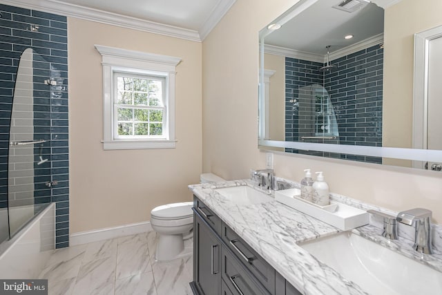 full bathroom featuring toilet, ornamental molding, a sink, and marble finish floor