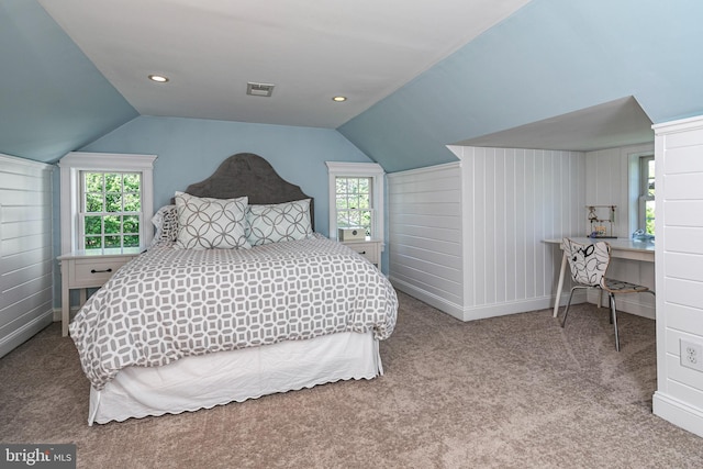 bedroom with visible vents, carpet flooring, lofted ceiling, and multiple windows