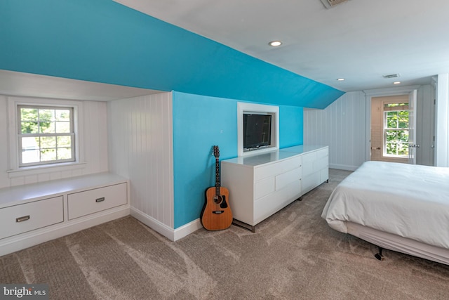 carpeted bedroom with baseboards, vaulted ceiling, and visible vents