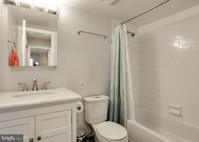 full bathroom featuring toilet, shower / bath combo, and vanity