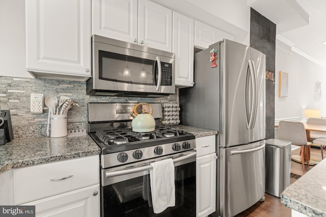 102 N Glover St, Baltimore, MD 21224 - kitchen with white cabinets, appliances with stainless steel finishes, ornamental molding, and dark wood-type flooring