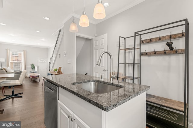102 N Glover St, Baltimore, MD 21224 - kitchen with stainless steel dishwasher, an island with sink, dark wood-type flooring, white cabinetry, and a sink