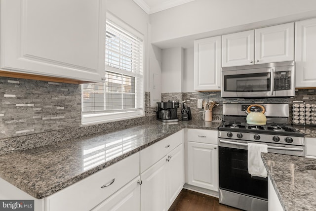 102 N Glover St, Baltimore, MD 21224 - kitchen with appliances with stainless steel finishes, tasteful backsplash, white cabinets, dark stone counters, and ornamental molding