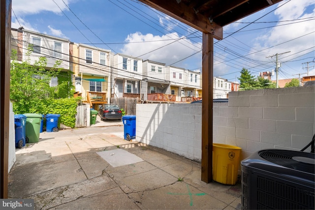 102 N Glover St, Baltimore, MD 21224 - view of patio / terrace with central AC unit, fence, and a residential view