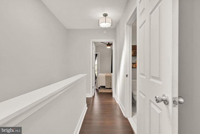 102 N Glover St, Baltimore, MD 21224 - hallway featuring baseboards, dark wood finished floors, and an upstairs landing