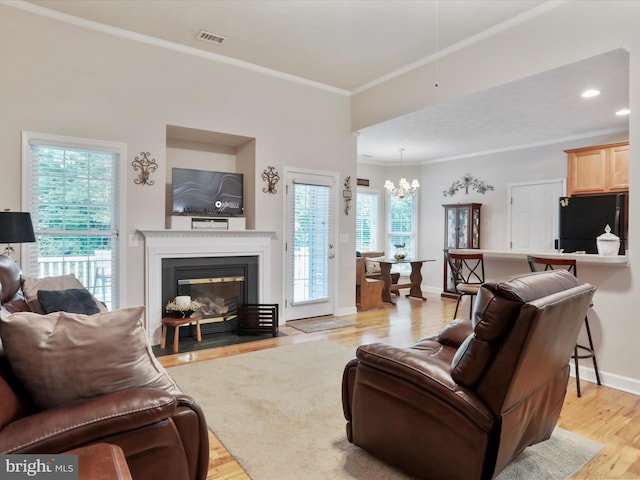 103 Potters Cir, Strasburg, VA 22657 - living area with a chandelier, light wood-style floors, crown molding, baseboards, and a fireplace with flush hearth