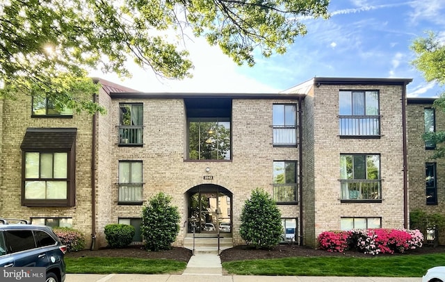 view of property featuring brick siding