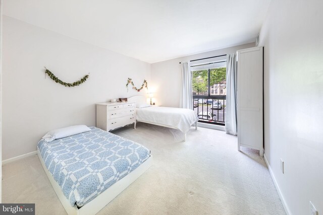 bedroom with light carpet and baseboards