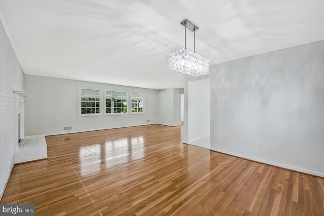 205 Dunbeath Ct, Lutherville Timonium, MD 21093 - unfurnished living room featuring a chandelier, wood finished floors, and baseboards