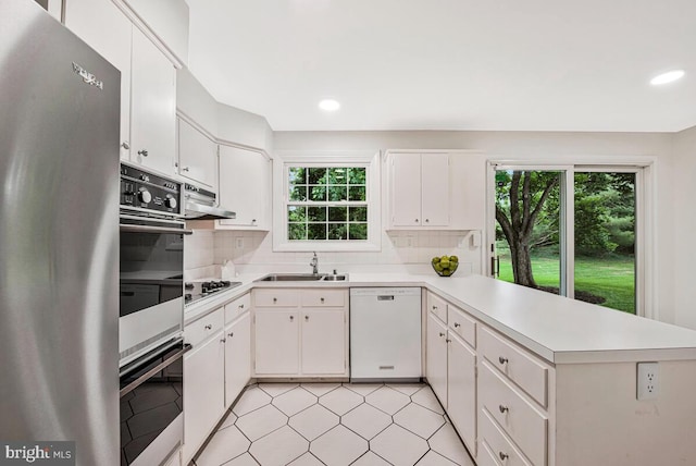 205 Dunbeath Ct, Lutherville Timonium, MD 21093 - kitchen featuring dishwasher, a sink, a peninsula, light countertops, and black stovetop