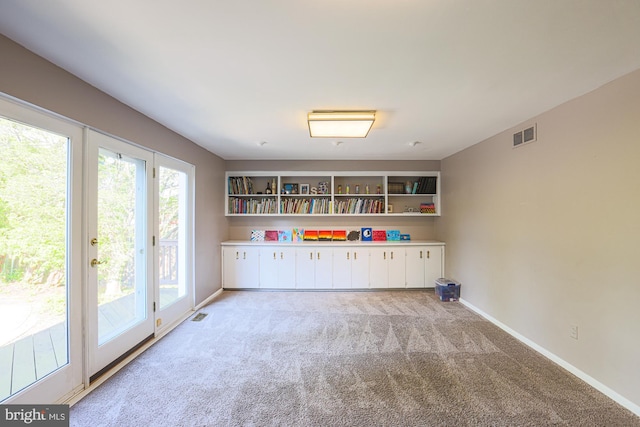 playroom featuring light colored carpet, baseboards, and visible vents