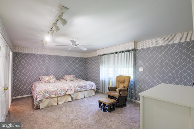 bedroom featuring a ceiling fan, tile walls, track lighting, carpet, and wallpapered walls