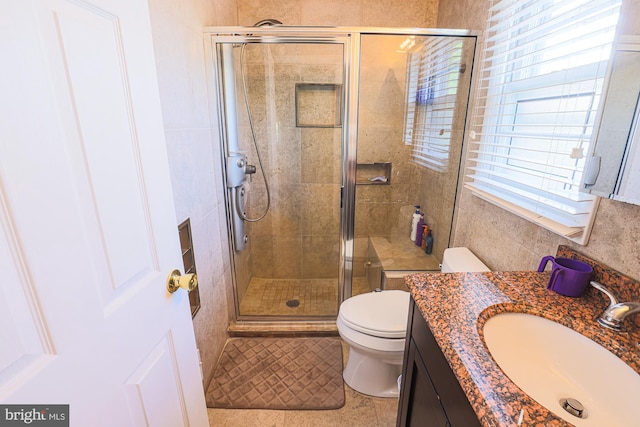 full bathroom featuring toilet, a shower stall, and vanity