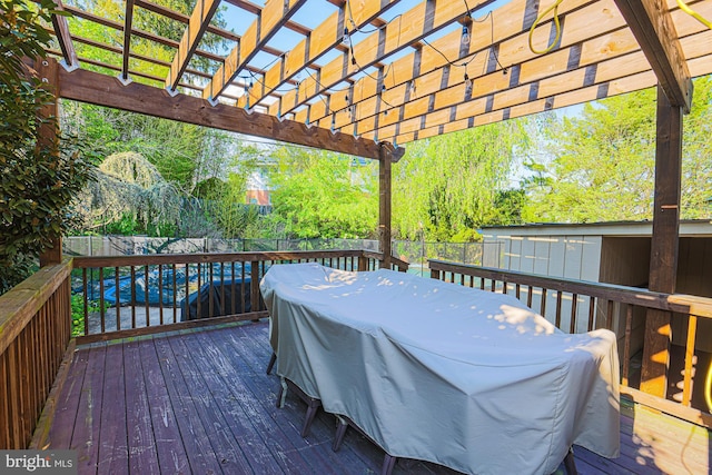 deck with a fenced backyard and a pergola