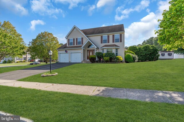 12 Jon Dr, Barnegat, NJ 08005 - view of front facade featuring a garage, a front lawn, and driveway