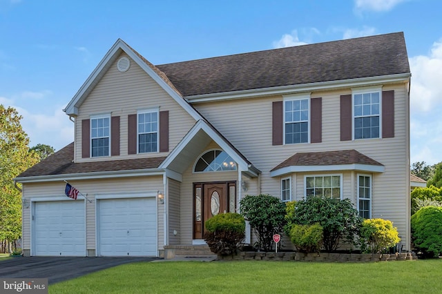12 Jon Dr, Barnegat, NJ 08005 - traditional home featuring a front lawn, driveway, roof with shingles, and an attached garage