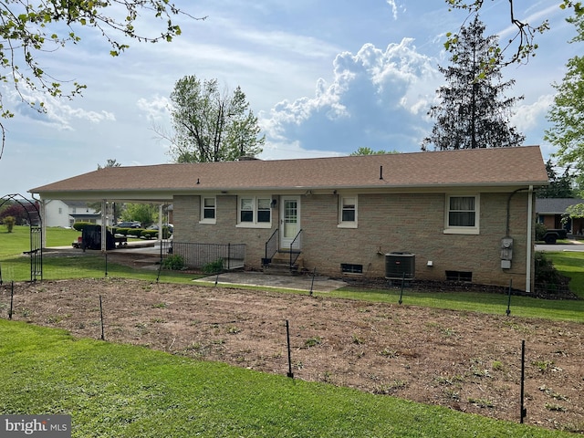 back of house with a patio area, brick siding, a yard, entry steps, and an attached carport