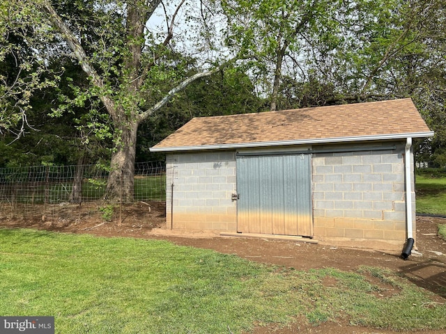 view of shed featuring fence