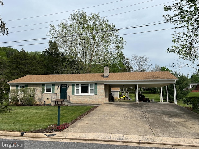 ranch-style house featuring a chimney, an attached carport, driveway, and a front lawn