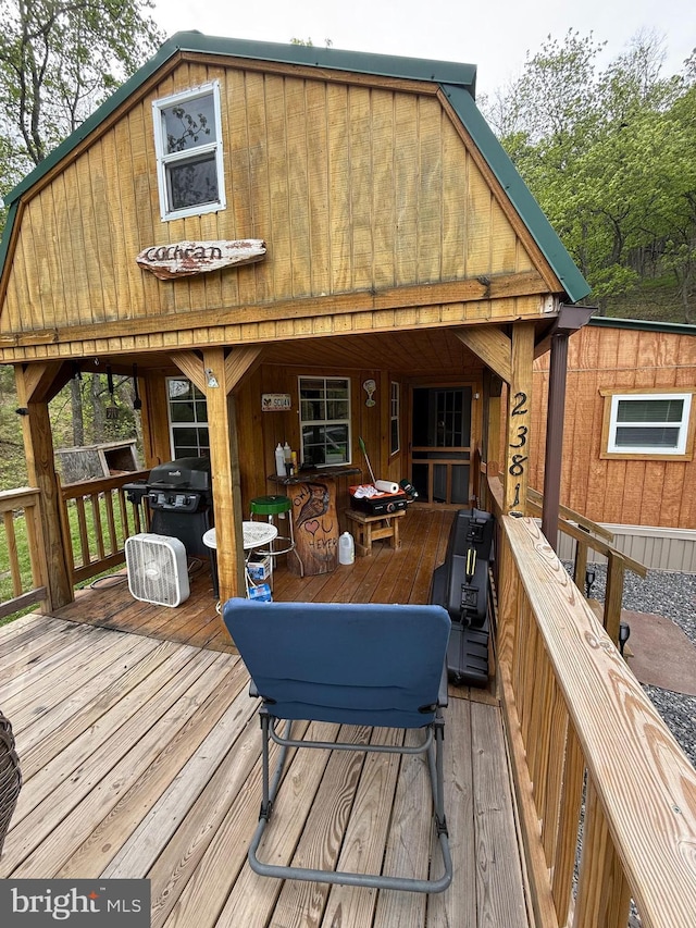 wooden deck featuring area for grilling
