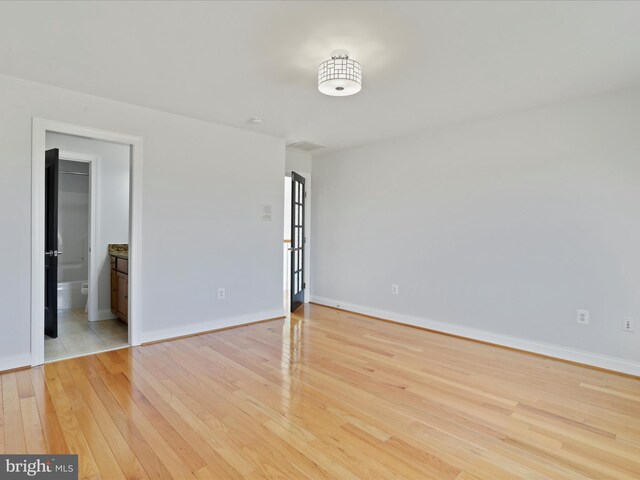 191 Inez Ln, Stephens City, VA 22655 - unfurnished bedroom featuring baseboards, ensuite bathroom, and light wood finished floors