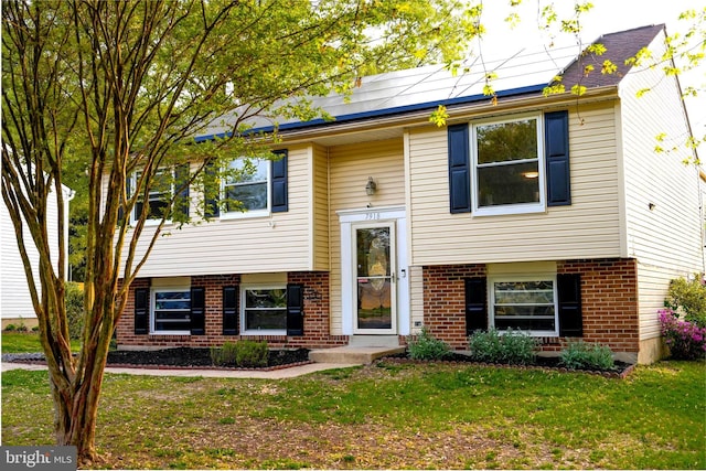 7918 Royal Mint Pl, Pasadena, MD 21122 - raised ranch with brick siding, solar panels, and a front yard