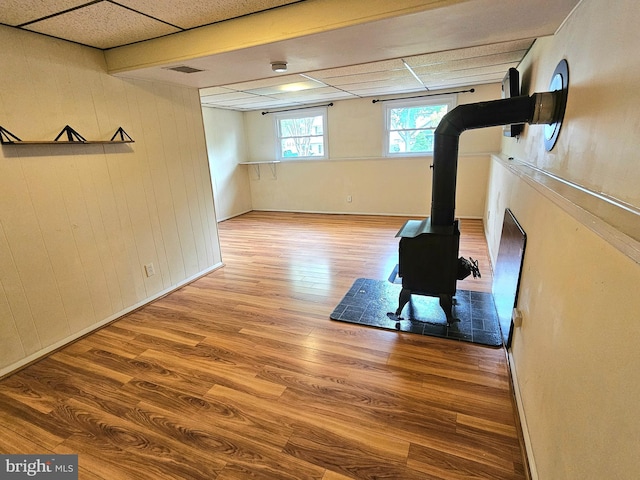 7918 Royal Mint Pl, Pasadena, MD 21122 - exercise area with a wood stove and wood finished floors