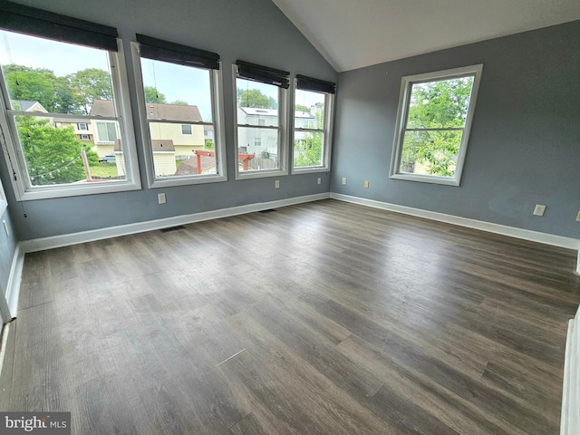 7918 Royal Mint Pl, Pasadena, MD 21122 - empty room with dark wood finished floors, plenty of natural light, vaulted ceiling, and baseboards